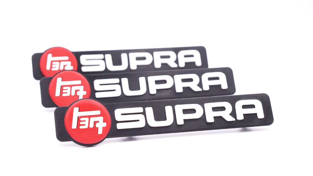 thumbnail image 2 of Toyota Supra Turbo Emblem Set – 1993–1998 – Front Bumper & Rear Lift Gate – OEM 75471-14010 2 of 3